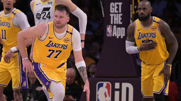 Feb 10, 2025; Los Angeles, California, USA; Los Angeles Lakers guard Luka Doncic (77) takes the ball down court as forward LeBron James (23) looks on against the Utah Jazz at Crypto.com Arena. Mandatory Credit: Jayne Kamin-Oncea-Imagn Images