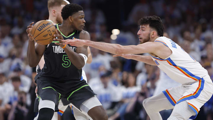 May 20, 2025; Oklahoma City, Oklahoma, USA; Minnesota Timberwolves guard Anthony Edwards (5) controls the ball against Oklahoma City Thunder forward Chet Holmgren (7) in the fourth quarter during game one of the western conference finals for the 2025 NBA Playoffs at Paycom Center. Mandatory Credit: Alonzo Adams-Imagn Images