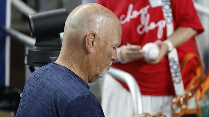 Jun 21, 2025; Miami, Florida, USA;  Atlanta Braves manager Brian Snitker (43) signs autographs against the Miami Marlins before the game at loanDepot Park. Mandatory Credit: Rhona Wise-Imagn Images