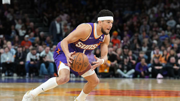 Phoenix Suns guard Devin Booker dribbles against the Detroit Pistons at Footprint Center.