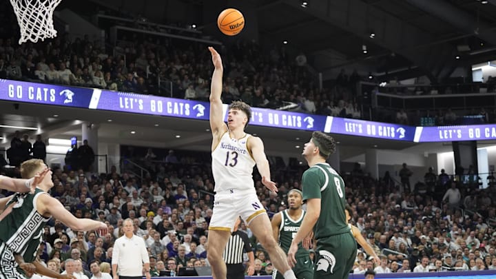 Jan 12, 2025; Evanston, Illinois, USA; Northwestern Wildcats guard Brooks Barnhizer (13) shoots over Michigan State Spartans forward Frankie Fidler (8) during the second half at Welsh-Ryan Arena. Mandatory Credit: David Banks-Imagn Images