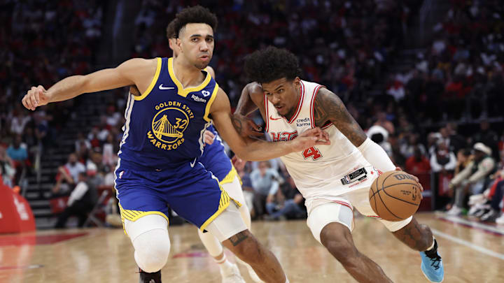 Apr 4, 2024; Houston, Texas, USA; Houston Rockets guard Jalen Green (4) drives against Golden State Warriors forward Trayce Jackson-Davis (32)  in the second half at Toyota Center. Mandatory Credit: Thomas Shea-Imagn Images