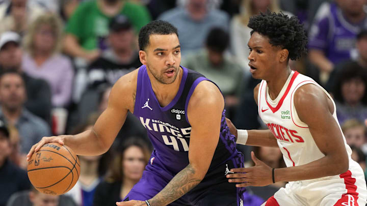Mar 10, 2024; Sacramento, California, USA; Sacramento Kings forward Trey Lyles (41) dribbles against Houston Rockets forward Amen Thompson (1) during the third quarter at Golden 1 Center. Mandatory Credit: Darren Yamashita-Imagn Images