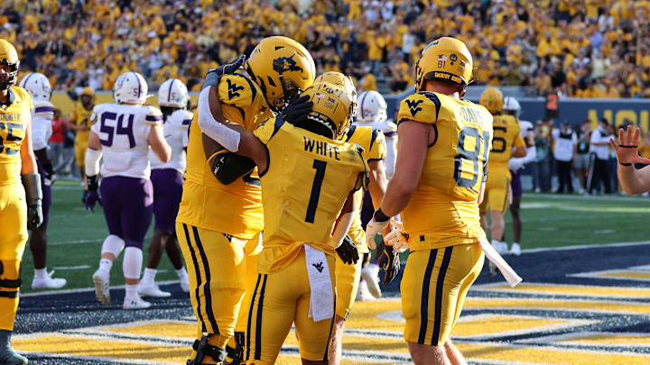 West Virginia University running back Jahiem White celebrates with teammates following his 14-yard touchdown run.