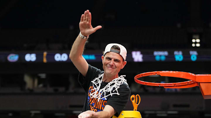 Apr 7, 2025; San Antonio, TX, USA; Florida Gators head coach Todd Golden reacts after cutting down a piece of the net after winning the national championship game of the Final Four of the 2025 NCAA Tournament at the Alamodome. Mandatory Credit: Bob Donnan-Imagn Images