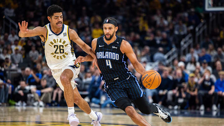 Nov 6, 2024; Indianapolis, Indiana, USA; Orlando Magic guard Jalen Suggs (4) dribbles the ball while Indiana Pacers guard Ben Sheppard (26) defends in the second half at Gainbridge Fieldhouse. Mandatory Credit: Trevor Ruszkowski-Imagn Images