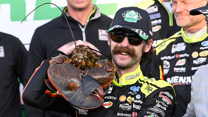 Aug 23, 2026; Loudon, New Hampshire, USA; Team Penske driver Ryan Blaney (12) poses with one of his prizes, Loudon the Lobster, after winning the Dollar Tree 301 at New Hampshire Motor Speedway. Aug 23, 2026; Loudon, New Hampshire, USA; Team Penske driver Ryan Blaney (12) poses with one of his prizes, Loudon the Lobster, after winning the Dollar Tree 301 at New Hampshire Motor Speedway.