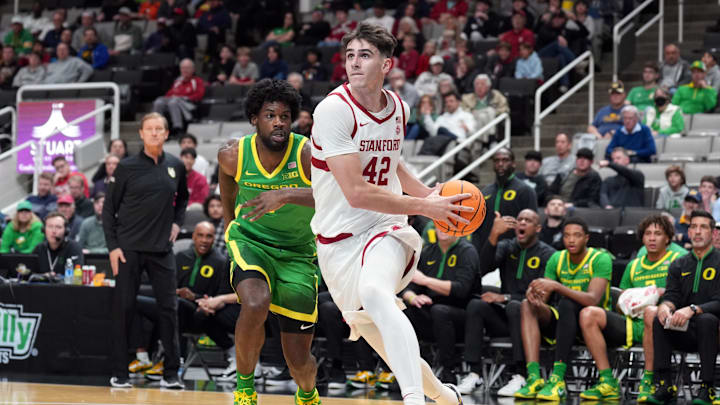 Dec 21, 2024; San Jose, California, USA; Stanford Cardinal forward Maxime Raynaud (42) drives against Oregon Ducks forward Supreme Cook (left) during the first half at SAP Center at San Jose. Mandatory Credit: Darren Yamashita-Imagn Images Dec 21, 2024; San Jose, California, USA; Stanford Cardinal forward Maxime Raynaud (42) drives against Oregon Ducks forward Supreme Cook (left) during the first half at SAP Center at San Jose. Mandatory Credit: Darren Yamashita-Imagn Images