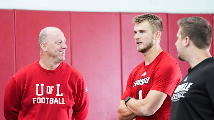Louisville football coach Jeff Brohm smiles while talking with quarterback Tyler Shough during the Pro Day workout for NFL scouts Tuesday, March 25, 2025.