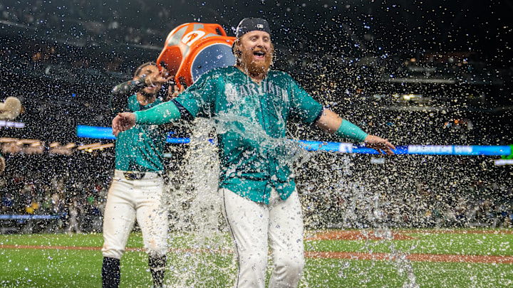 Seattle Mariners centerfielder Julio Rodriguez (44), left, douses pinch hitter Justin Turner (2) with water after a game against the Oakland Athletics at T-Mobile Park in 2024. Seattle Mariners centerfielder Julio Rodriguez (44), left, douses pinch hitter Justin Turner (2) with water after a game against the Oakland Athletics at T-Mobile Park in 2024.