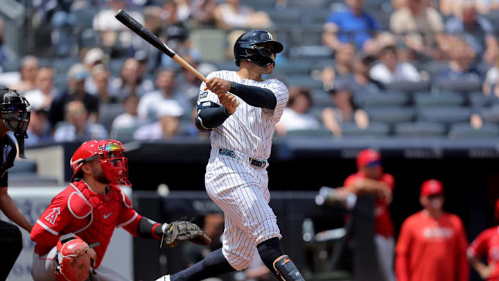 Jun 19, 2025; Bronx, New York, USA; New York Yankees center fielder Trent Grisham (12) follows through on a two run home run against the Los Angeles Angels during the second inning at Yankee Stadium. Mandatory Credit: Brad Penner-Imagn Images