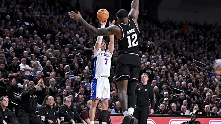 Feb 7, 2026; College Station, Texas, USA; Florida Gators guard Urban Klavzar (7) shoots a three point basket over Texas A&M Aggies forward Rashaun Agee (12) during the first half at Reed Arena. Mandatory Credit: Maria Lysaker-Imagn Images 
