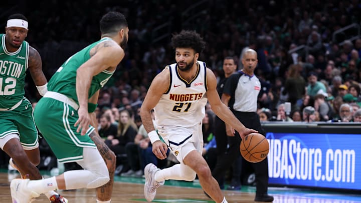 Mar 2, 2025; Boston, Massachusetts, USA; Denver Nuggets guard Jamal Murray (27) dribbles down the court defended by Boston Celtics forward Jayson Tatum (0) during the first half at TD Garden. Mandatory Credit: Paul Rutherford-Imagn Images