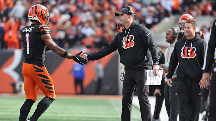 Oct 26, 2025; Cincinnati, Ohio, USA; Cincinnati Bengals wide receiver Ja'Marr Chase (1) shakes hands with head coach Zac Taylor during the fourth quarter against the New York Jets  at Paycor Stadium. Mandatory Credit: Joseph Maiorana-Imagn Images