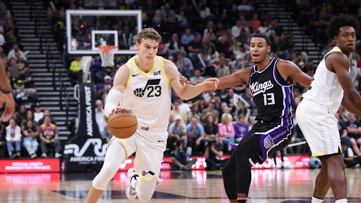 Oct 15, 2024; Salt Lake City, Utah, USA;  Utah Jazz forward Lauri Markkanen (23) drives against Sacramento Kings forward Keegan Murray (13) during the second quarter at Delta Center. Mandatory Credit: Rob Gray-Imagn Images