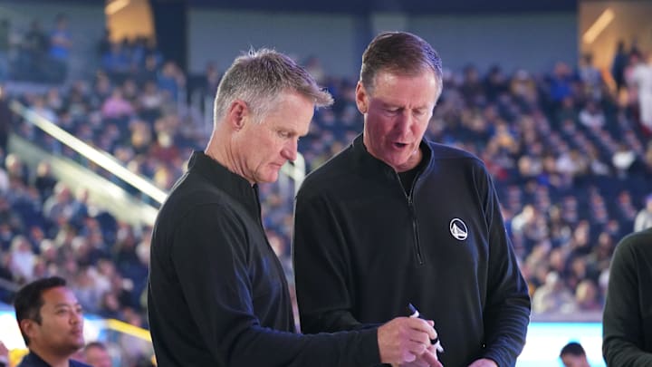 Oct 30, 2024; San Francisco, California, USA;  Golden State Warriors head coach Steve Kerr writes on his whiteboard while assistant coach Terry Stotts looks on before the game against the New Orleans Pelicans at Chase Center. Mandatory Credit: David Gonzales-Imagn Images