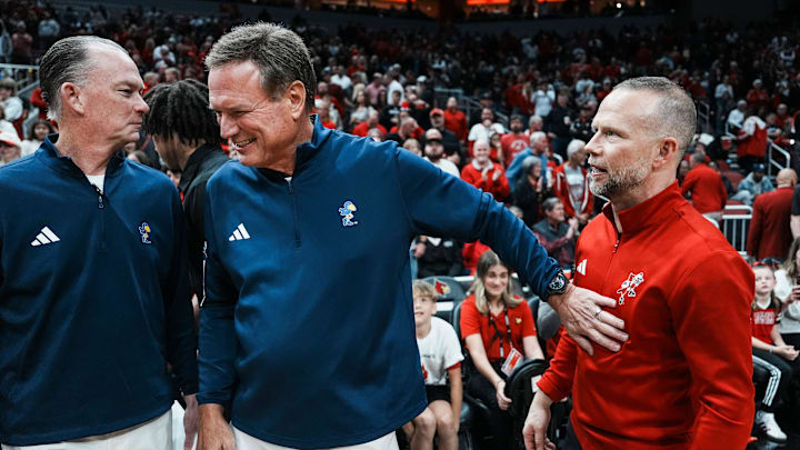 Kansas Jayhawks head coach Bill Self greets Louisville Cardinals head coach Pat Kelsey before the start of the exhibition game at the KFC Yum! Center in Louisville, Kentucky Friday, October 24, 2025. Kansas Jayhawks head coach Bill Self greets Louisville Cardinals head coach Pat Kelsey before the start of the exhibition game at the KFC Yum! Center in Louisville, Kentucky Friday, October 24, 2025.