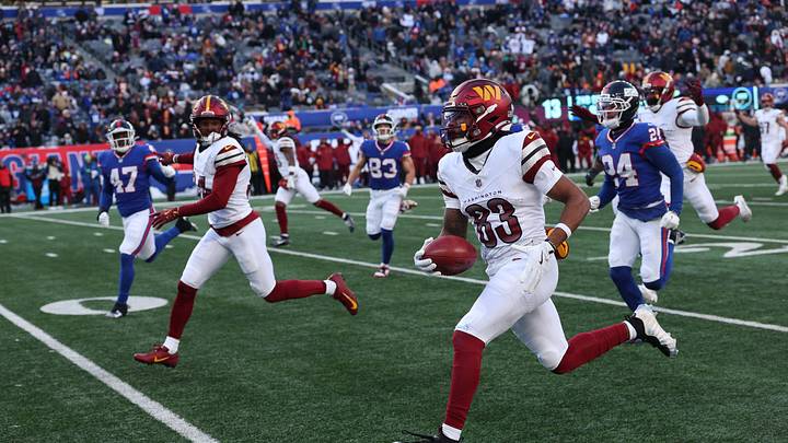 Dec 14, 2025; East Rutherford, New Jersey, USA;  Washington Commanders wide receiver Jaylin Lane (83) runs the ball for a punt return touchdown during the second quarter against the New York Giants at MetLife Stadium. Mandatory Credit: Vincent Carchietta-Imagn Images