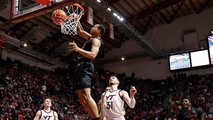 Jan 13, 2024; Blacksburg, Virginia, USA; Miami Hurricanes guard Matthew Cleveland (0) dunks the ball against Virginia Tech Hokies forward Robbie Beran (31) during the first half at Cassell Coliseum. Mandatory Credit: Peter Casey-Imagn Images