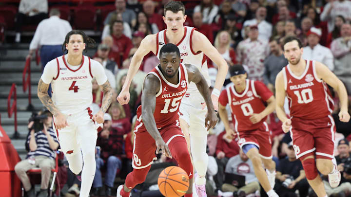 Jan 25, 2025; Fayetteville, Arkansas, USA; Oklahoma Sooners guard Duke Miles (15) controls the ball against Arkansas Razorbacks forward Zvonimir Ivisic (44) in the first half at Bud Walton Arena. Mandatory Credit: Nelson Chenault-Imagn Images