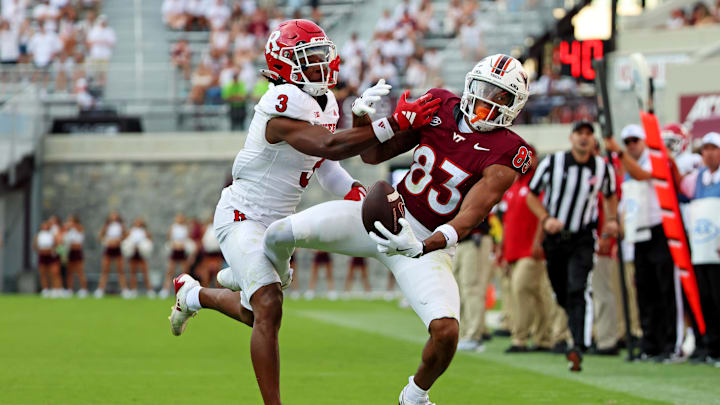 Sep 21, 2024; Blacksburg, Virginia, USA; Virginia Tech Hokies wide receiver Jaylin Lane (83) jumps for a pass against Rutgers Scarlet Knights defensive back Bo Mascoe (3) during the third quarter at Lane Stadium. Mandatory Credit: Peter Casey-Imagn Images