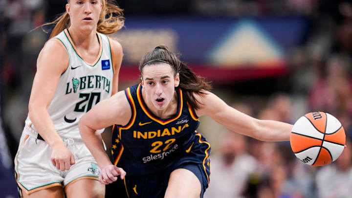 Indiana Fever guard Caitlin Clark (22) rushes up the court past New York Liberty guard Sabrina