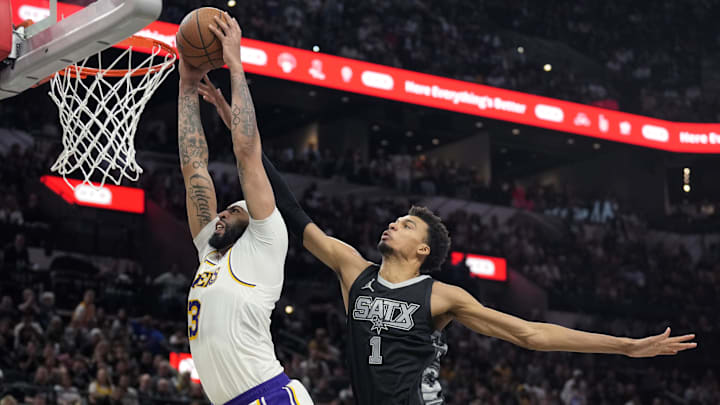 Nov 15, 2024; San Antonio, Texas, USA; Los Angeles Lakers forward Anthony Davis (3) goes up to dunk past San Antonio Spurs center Victor Wembanyama (1) during the second half at Frost Bank Center. Mandatory Credit: Scott Wachter-Imagn Images