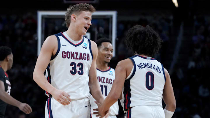 Mar 20, 2025; Wichita, KS, USA; Gonzaga Bulldogs forward Ben Gregg (33) celebrates with guard Ryan Nembhard (0) and guard Nolan Hickman (11) after a play in the first half of a first round men’s NCAA Tournament game against the Georgia Bulldogs at Intrust Bank Arena. 