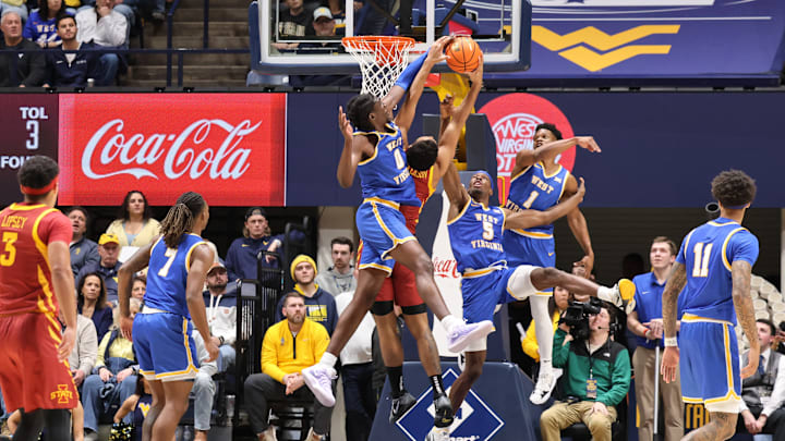 West Virginia University center Eduardo Andre (0) blocks the shot of Iowa State forward Joshua Johnson while WVU guards Toby Okani (5) and Joseph Yesufu (1) contest the shot. West Virginia University center Eduardo Andre (0) blocks the shot of Iowa State forward Joshua Johnson while WVU guards Toby Okani (5) and Joseph Yesufu (1) contest the shot.