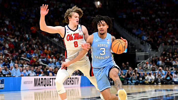 Mar 21, 2025; Milwaukee, WI, USA; North Carolina Tar Heels guard Elliot Cadeau (3) drives against Mississippi Rebels guard Eduardo Klafke (8) during the first half of a first round NCAA men’s tournament game at Fiserv Forum. Mandatory Credit: Benny Sieu-Imagn Images