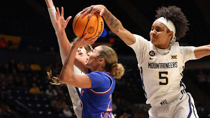 West Virginia guard Sydney Shaw blocks the layup of Kansas guard Sania Copeland. West Virginia guard Sydney Shaw blocks the layup of Kansas guard Sania Copeland.