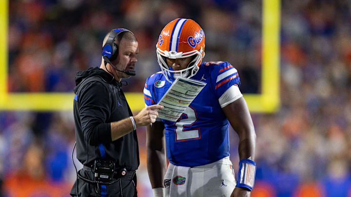 Oct 19, 2024; Gainesville, Florida, USA; Florida Gators head coach Billy Napier and Florida Gators quarterback DJ Lagway (2) review a play against the Kentucky Wildcats during the second half at Ben Hill Griffin Stadium. Mandatory Credit: Matt Pendleton-Imagn Images