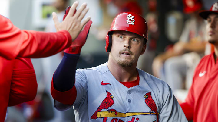 Sep 9, 2025; Seattle, Washington, USA; St. Louis Cardinals third baseman Nolan Gorman (16) high-fives teammates in the dugout after scoring a run against the Seattle Mariners during the second inning at T-Mobile Park. Mandatory Credit: Joe Nicholson-Imagn Images