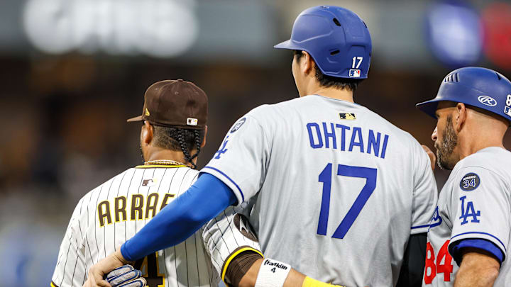 Jun 9, 2025; San Diego, California, USA;  Los Angeles Dodgers designated hitter Shohei Ohtani (17) hugs San Diego Padres first baseman Luis Arraez (4) after drawing a walk during the fourth inning against the San Diego Padres at Petco Park. Mandatory Credit: David Frerker-Imagn Images