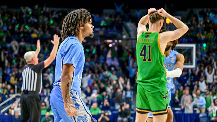 Jan 4, 2025; South Bend, Indiana, USA; North Carolina Tar Heels guard Elliot Cadeau (3) and Notre Dame Fighting Irish guard Matt Allocco (41) react after Nadeau was fouled by Allocco on a three-point basket at the end of the second half at the Purcell Pavilion. Mandatory Credit: Matt Cashore-Imagn Images