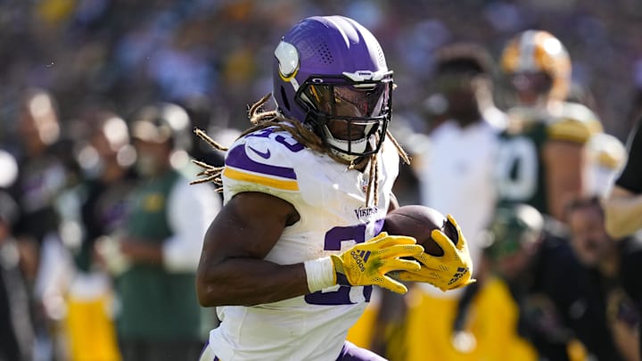 Sep 29, 2024; Green Bay, Wisconsin, USA;  Minnesota Vikings running back Aaron Jones (33) rushes with the football during the fourth quarter against the Green Bay Packers at Lambeau Field.