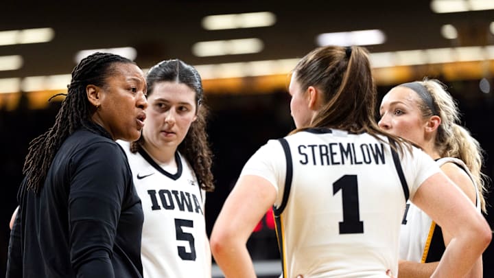 Iowa assistant coach Lasondra Barrett huddles with Iowa’s Ava Heiden (5), Taylor Stremlow (1) and Kylie Feuerbach (4) during a game against the Illinois Fighting Illini Feb. 26, 2026 at Carver-Hawkeye Arena in Iowa City, Iowa. Iowa assistant coach Lasondra Barrett huddles with Iowa’s Ava Heiden (5), Taylor Stremlow (1) and Kylie Feuerbach (4) during a game against the Illinois Fighting Illini Feb. 26, 2026 at Carver-Hawkeye Arena in Iowa City, Iowa.