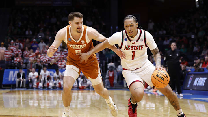 Mar 17, 2026; Dayton, OH, USA; NC State Wolfpack forward Darrion Williams (1) dribbles defended by Texas Longhorns forward Camden Heide (5) in the first half  during a first four game of the men's 2026 NCAA Tournament at University of Dayton Arena. Mandatory Credit: Rick Osentoski-Imagn Images