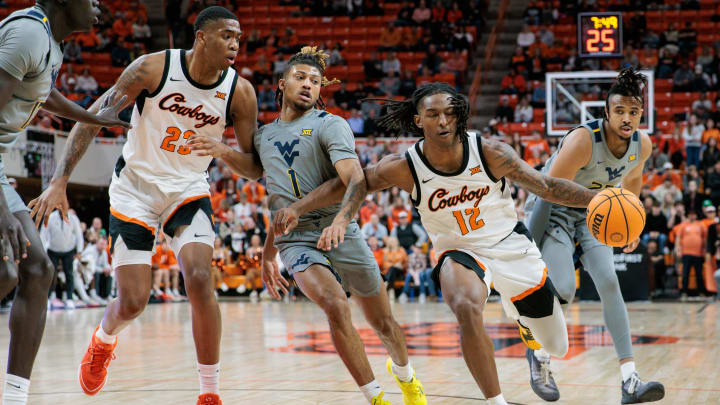 Jan 27, 2024; Stillwater, Oklahoma, USA; Oklahoma State Cowboys guard Javon Small (12) drives to the basket against West Virginia Mountaineers guard Noah Farrakhan (1) during the first half at Gallagher-Iba Arena. Mandatory Credit: William Purnell-USA TODAY Sports Jan 27, 2024; Stillwater, Oklahoma, USA; Oklahoma State Cowboys guard Javon Small (12) drives to the basket against West Virginia Mountaineers guard Noah Farrakhan (1) during the first half at Gallagher-Iba Arena. Mandatory Credit: William Purnell-USA TODAY Sports