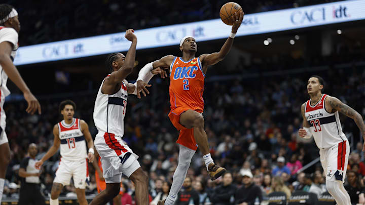 Jan 12, 2025; Washington, District of Columbia, USA; Oklahoma City Thunder guard Shai Gilgeous-Alexander (2) shoots the ball as Washington Wizards forward Alexandre Sarr (20) defends in the third quarter at Capital One Arena. Mandatory Credit: Geoff Burke-Imagn Images