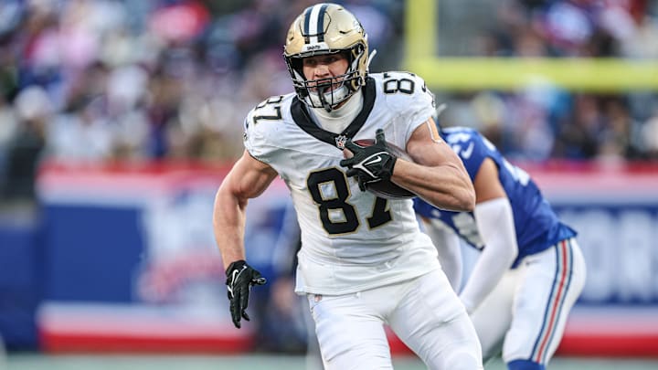 Dec 8, 2024; East Rutherford, New Jersey, USA; New Orleans Saints tight end Foster Moreau (87) makes a catch during the second half in front of New York Giants safety Dane Belton (24) at MetLife Stadium. Mandatory Credit: Vincent Carchietta-Imagn Images