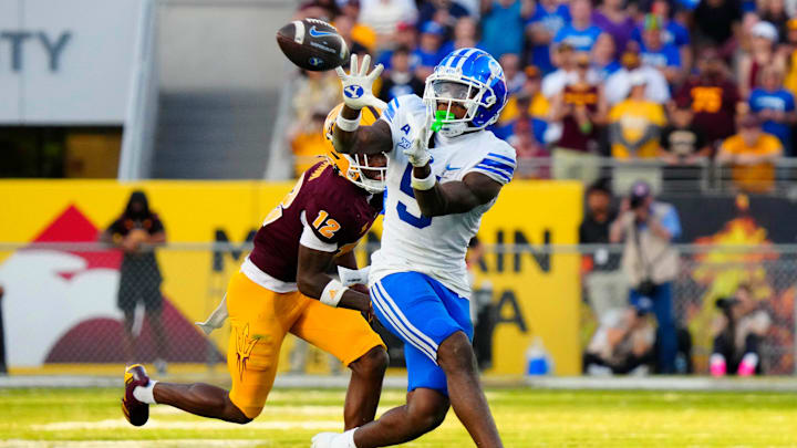 BYU wide receiver Darius Lassiter (5) makes a catch against Arizona State defensive back Javan Robinson (12) during the second half at Mountain America Stadium in Tempe on Nov. 23, 2024.