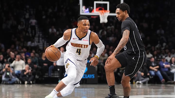 Denver Nuggets point guard Russell Westbrook (4) dribbles the ball against Brooklyn Nets guard Keon Johnson (45) during the first half at Barclays Center. Denver Nuggets point guard Russell Westbrook (4) dribbles the ball against Brooklyn Nets guard Keon Johnson (45) during the first half at Barclays Center.