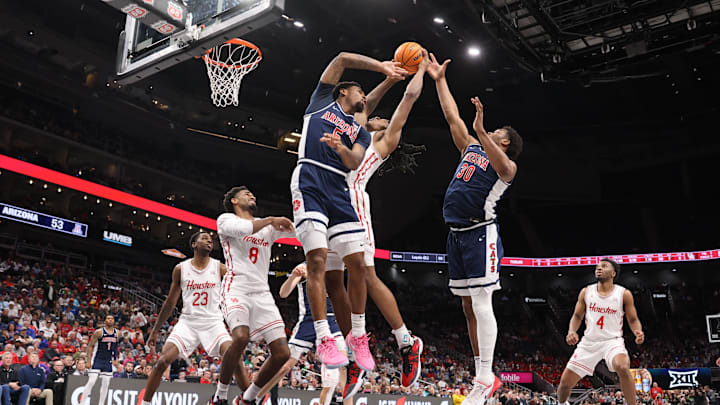 Mar 15, 2025; Kansas City, MO, USA; Arizona Wildcats guard KJ Lewis (5), forward Tobe Awaka (30) attempt to grab a rebound against Houston Cougars forward Joseph Tugler (11) during the second half for the Big 12 Conference Tournament Championship game at T-Mobile Center. Mandatory Credit: William Purnell-Imagn Images