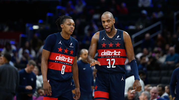 Mar 5, 2025; Washington, District of Columbia, USA; Washington Wizards forward Khris Middleton (32) and guard Bub Carrington (8) talk during the third quarter against the Utah Jazz at Capital One Arena. Mandatory Credit: Reggie Hildred-Imagn Images