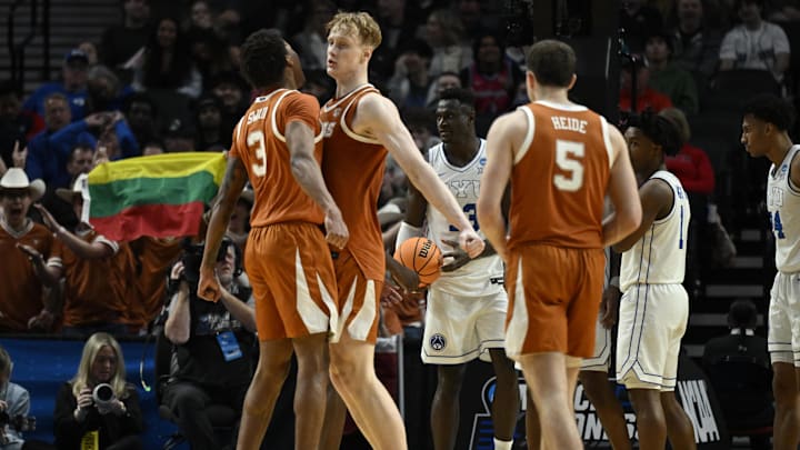  Texas Longhorns forward Dailyn Swain (3) and center Matas Vokietaitis (8) celebrate after a play in the second half against the BYU Cougars during a first round game of the men's 2026 NCAA Tournament at Moda Center. Mandatory Credit: Troy Wayrynen-Imagn Images