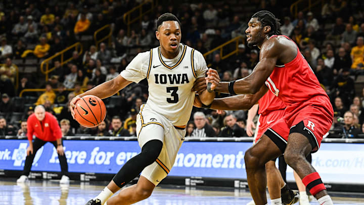 Jan 20, 2026; Iowa City, Iowa, USA; Iowa Hawkeyes forward Cam Manyawu (3) goes to the basket as Rutgers Scarlet Knights center Emmanuel Ogbole (21) defends during the 2nd half at Carver-Hawkeye Arena. Mandatory Credit: Jeffrey Becker-Imagn Images