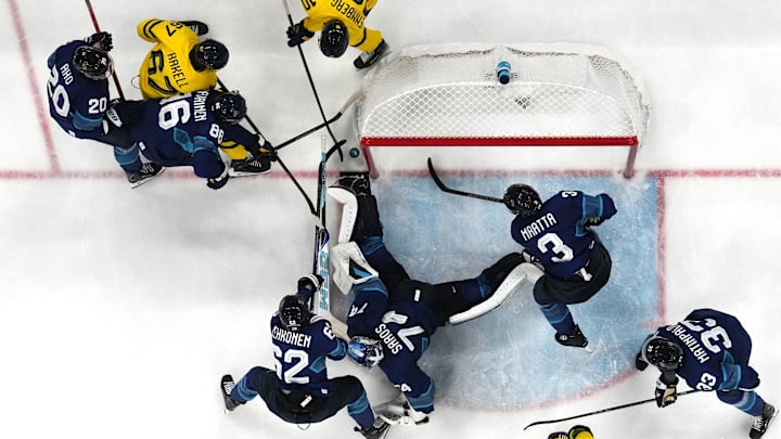 [US, Mexico & Canada customers only] Feb 13, 2026; Milan, Italy;  Juuse Saros of Finland, Sebastian Aho of Finland, and Teuvo Teravainen of Finland in action with Rickard Rakell of Sweden and Alexander Wennberg of Sweden in men's ice hockey Group B play during the Milano Cortina 2026 Olympic Winter Games at Milano Santagiulia Ice Hockey Arena. Mandatory Credit: Marton Monus/Reuters via Imagn Images