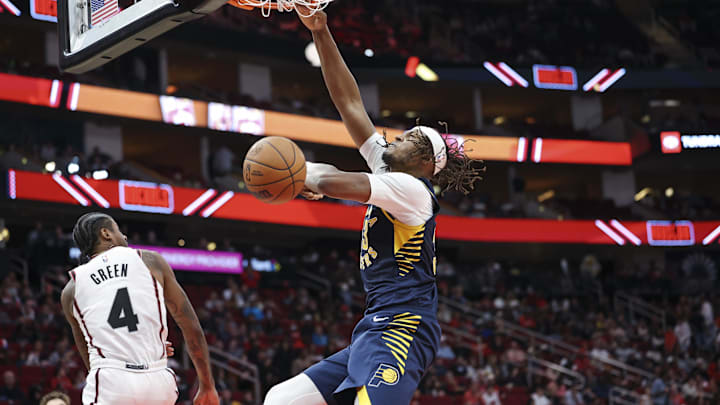 Nov 20, 2024; Houston, Texas, USA; Indiana Pacers center Myles Turner (33) dunks the ball as Houston Rockets guard Jalen Green (4) defends during the third quarter at Toyota Center. Mandatory Credit: Troy Taormina-Imagn Images