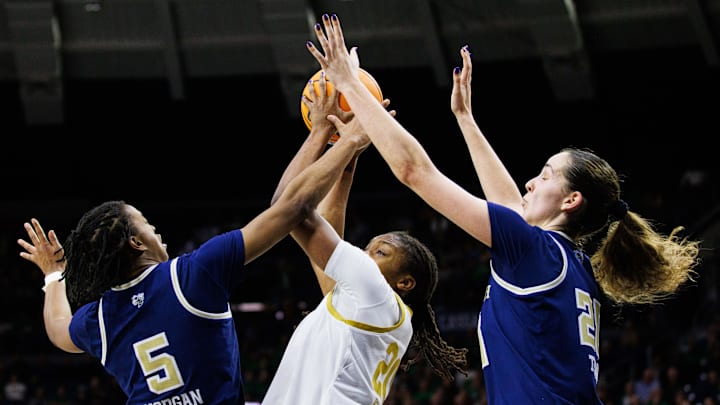 Notre Dame forward Liatu King (20) keeps the ball away from Georgia Tech guard Tonie Morgan (5) and center Ariadna Termis (20) during a NCAA women's basketball game between Notre Dame and Georgia Tech at Purcell Pavilion on Thursday, Jan. 16, 2025, in South Bend.